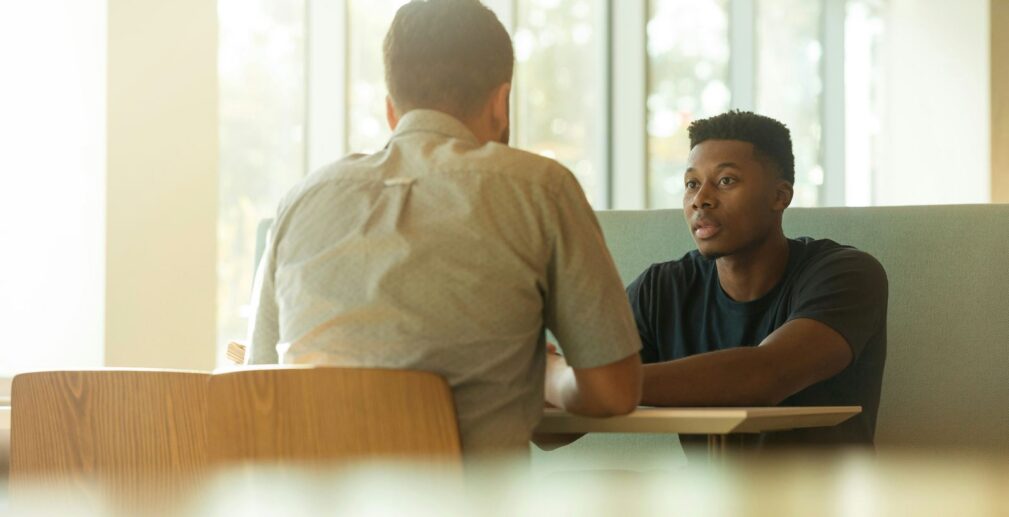 A manager and employee in a focused one-on-one coaching conversation